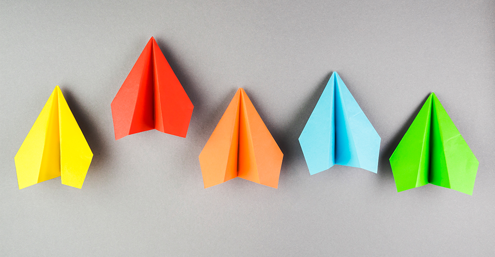 Five paper airplanes in different colours